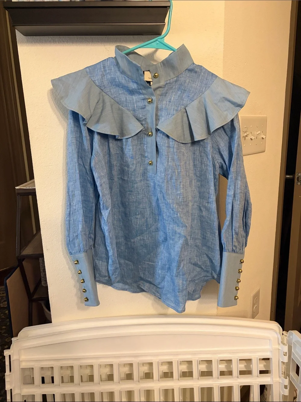 Tuckernuck Mirabella ruffle bib blouse in chambray blue linen.